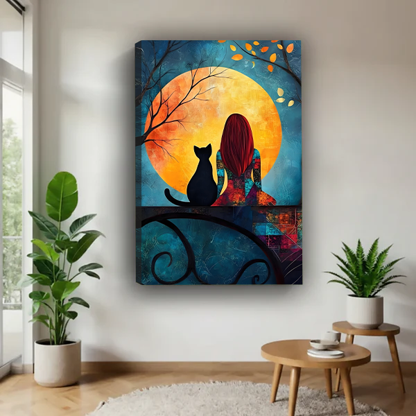 Framed woman and black cat moon canvas wall art displayed beside a rattan bed with terracotta bedding.