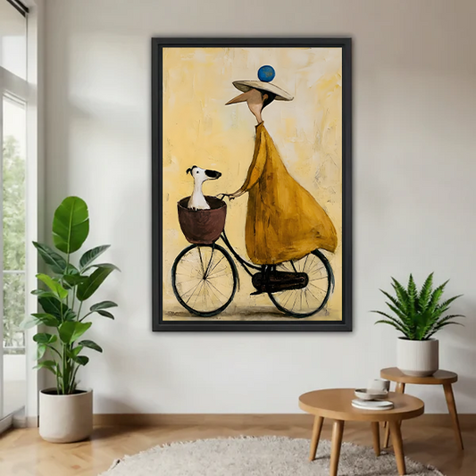Framed woman and dog bicycle canvas wall art featuring a mustard-yellow dress displayed between green houseplants.