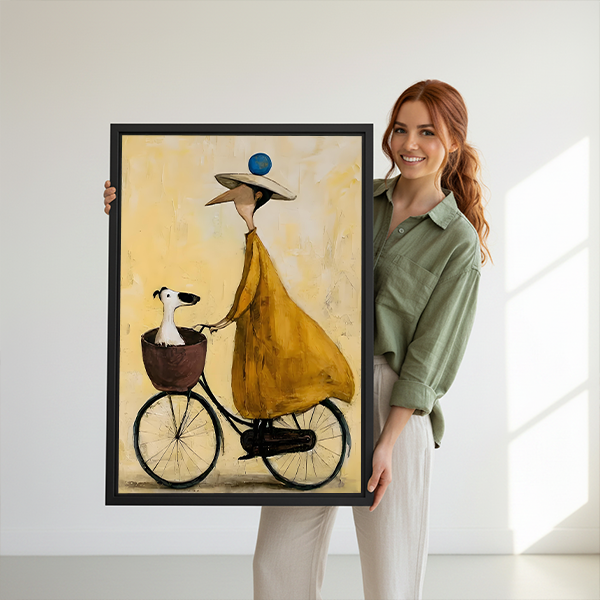 Woman and dog bicycle canvas wall art in a black frame beside a rattan bed with terracotta bedding.