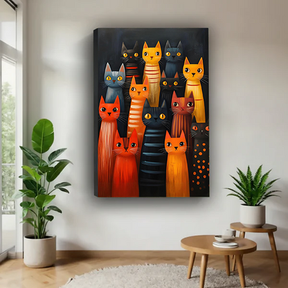 Woman holding framed colorful cat canvas wall art featuring orange, black, and gray cats in a bright room