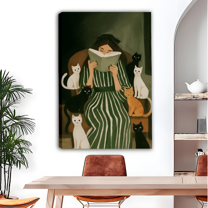 Woman reading with cats canvas wall art in a black frame above a dining table beside a mirror