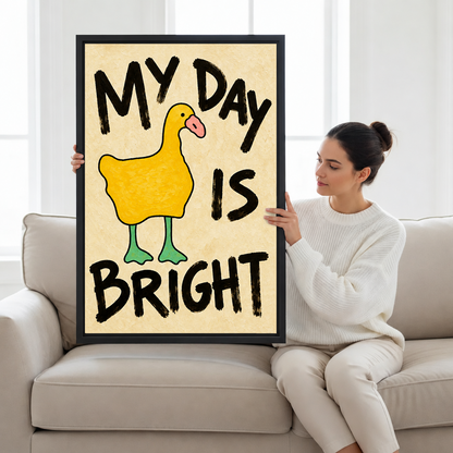 Woman in a white sweater holding a large yellow duck My Day Is Bright framed canvas wall art on a beige sofa