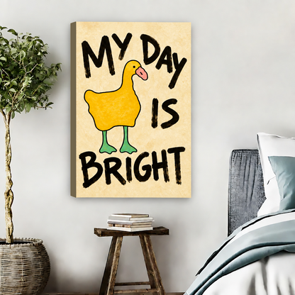 Frameless gallery wrap yellow duck My Day Is Bright canvas wall art beside a bed with a potted olive tree