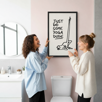  Two women laughing while hanging framed yoga frog canvas wall art in a pink bathroom