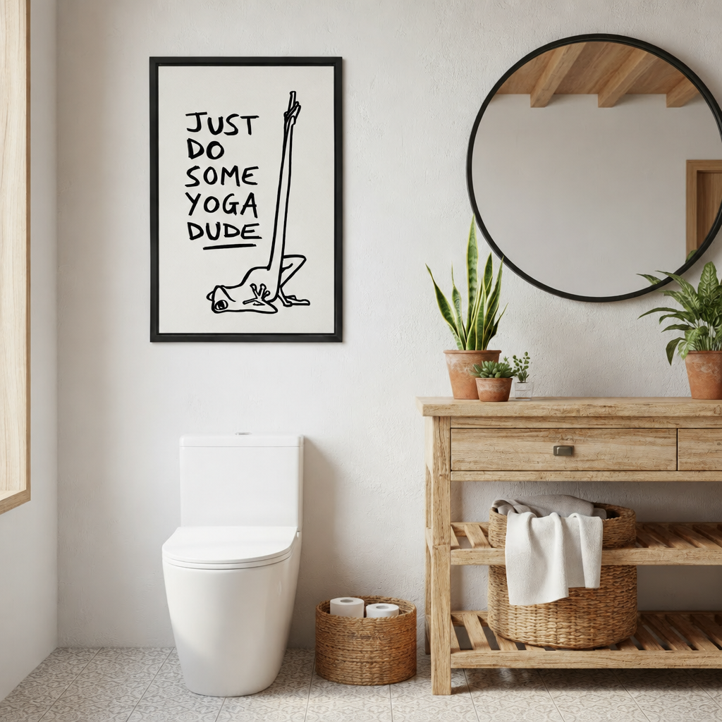 Framed yoga frog canvas wall art beside a round mirror and wooden vanity in a rustic bathroom